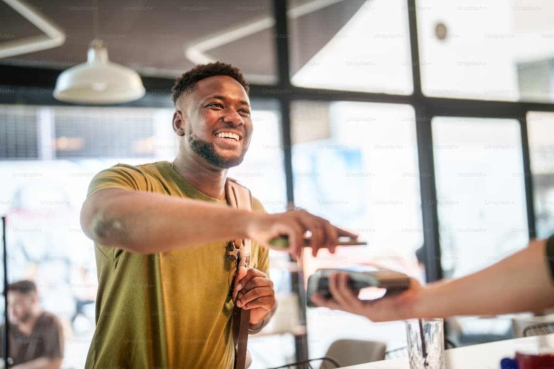 A smiling customer making a payment