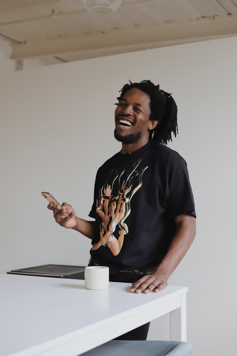 An investor smiling while holding his phone